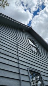 Antenna cable run up the side of the house to the roofline
